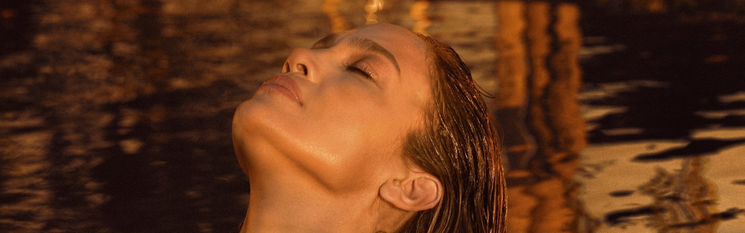 JLo in a pool at golden hour.