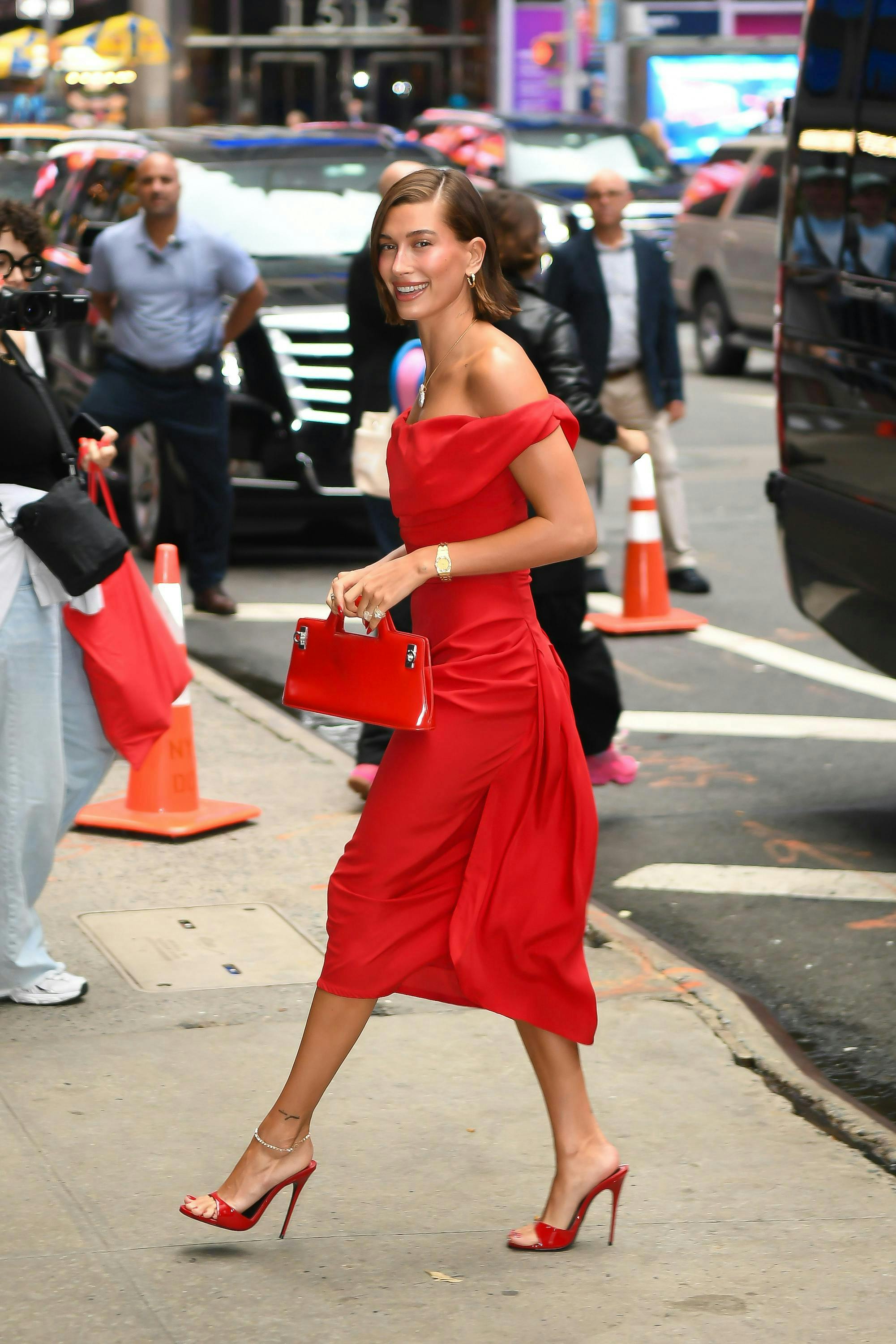 Hailey Bieber spotted in a red dress and red heels wearing an anklet.