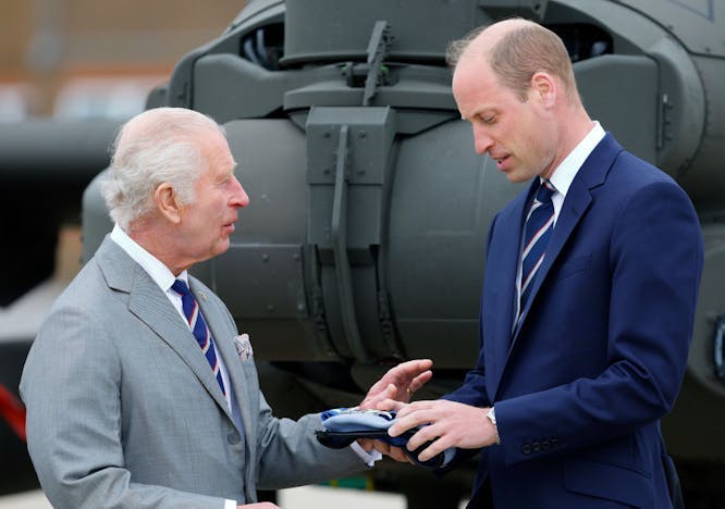 King Charles III presents Prince William, Prince of Wales with with the blue beret and belt of the Army Air Corps.