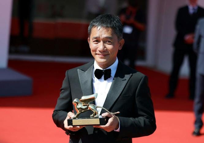 tony leung in black tuxedo at 2023 venice film festival