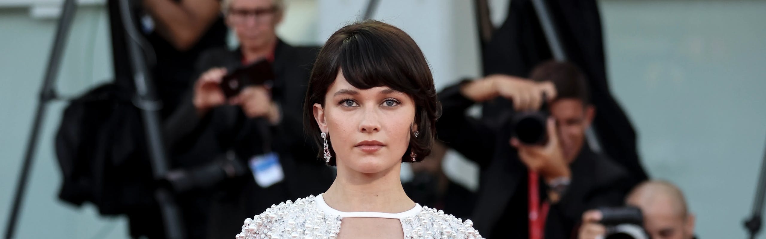cailee speany in a sequined white dress looking at the camera