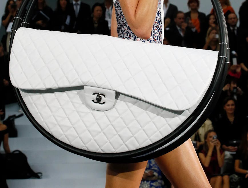 craziest designer handbags model carrying white quilted hula hoop bag on runway