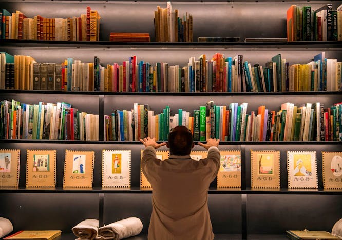fashion museum horizontal marrakech book library publication furniture adult male man person bookcase shelf