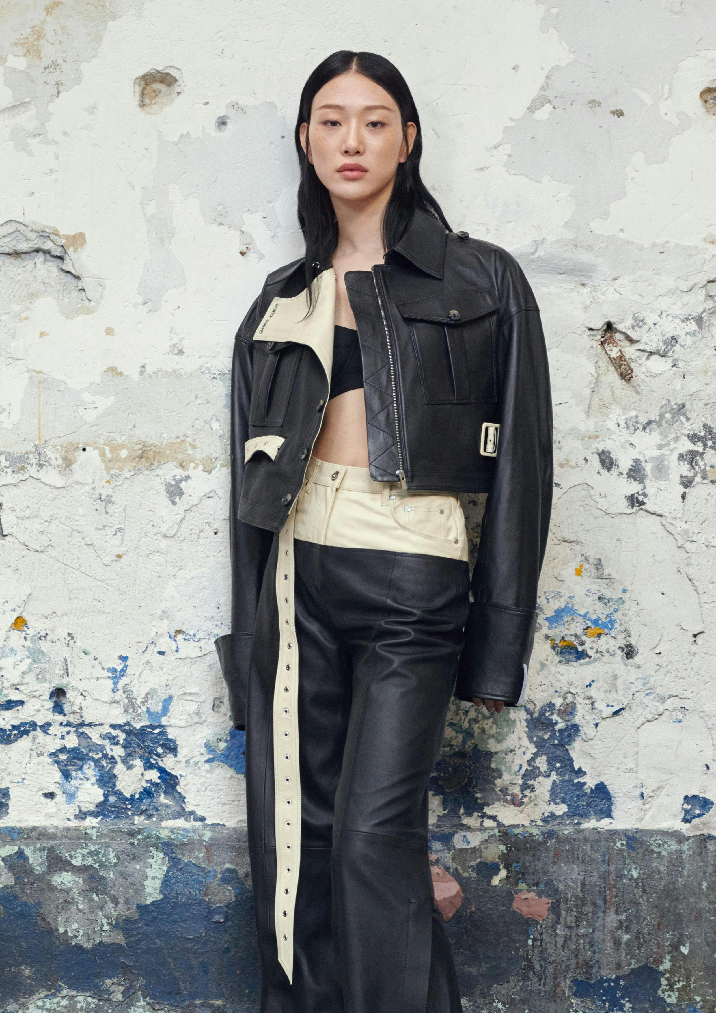 h&m x rokh collaboration: a woman wearing a black leather jacket and pants
