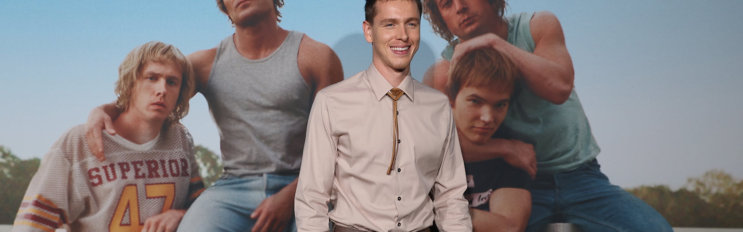 harris dickinson iron claw dallas premiere in a beige shirt and brown pants