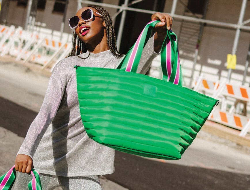 A woman carrying the Beach Bum Cooler Bag Maxi in green. / best-coolers