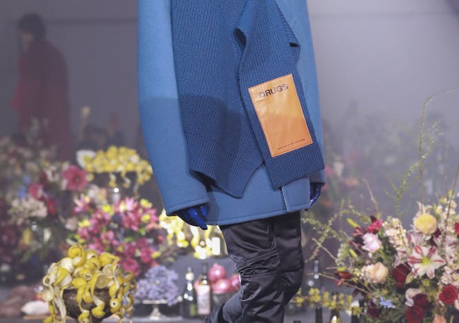 clothing apparel coat person human plant flower arrangement flower blossom flower bouquet
