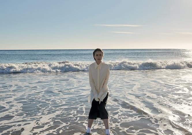 sea nature outdoors water person clothing shorts shoreline beach coast