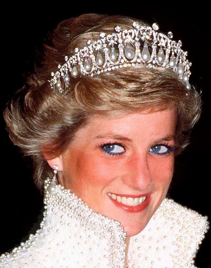Princess Diana wearing a diamon and pearl tiara on a black background
