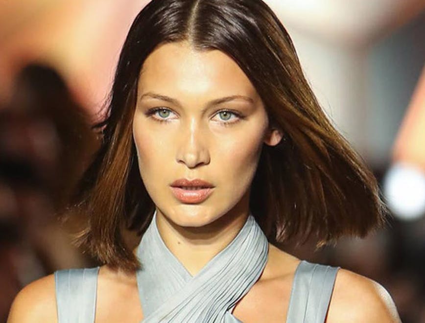 Bella Hadid walking the runway with her short hair being blown back