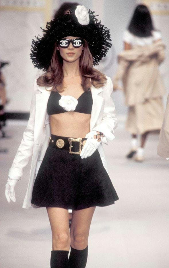 Kate Moss wears logo shades on the Chanel Spring/Summer 1993 runway.