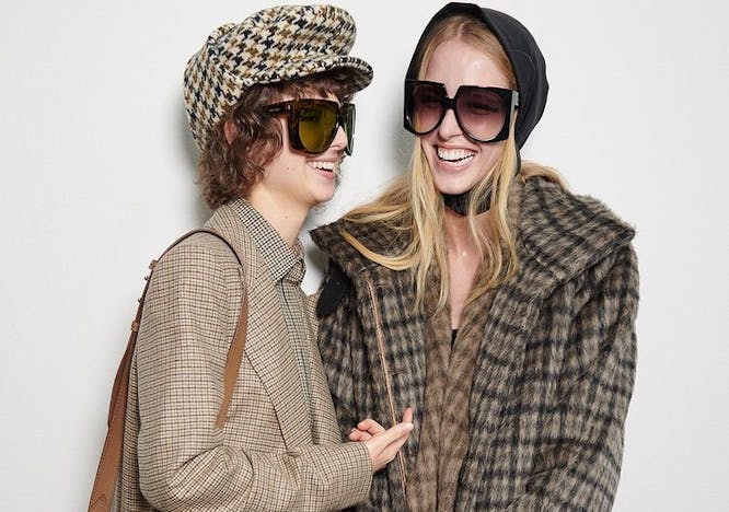 clothing apparel sunglasses accessories person overcoat coat sleeve handbag bag
