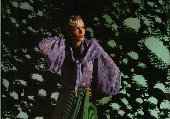 A model wears Yves Saint Laurent in a 1976 issue of L'OFFICIEL Paris, photographed by Patrick Bertrand.