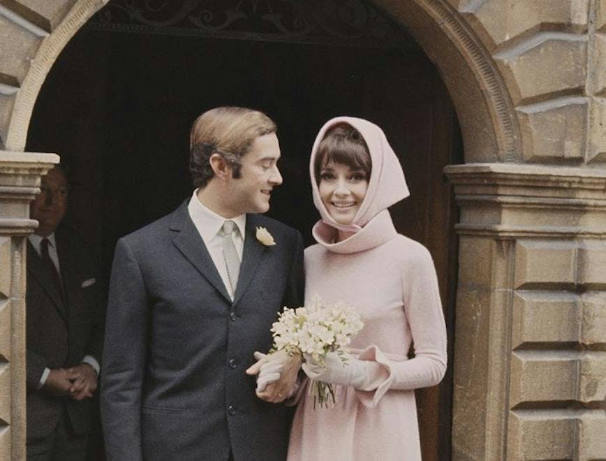 Audrey Hepburn in a hooded pink dress for her wedding.