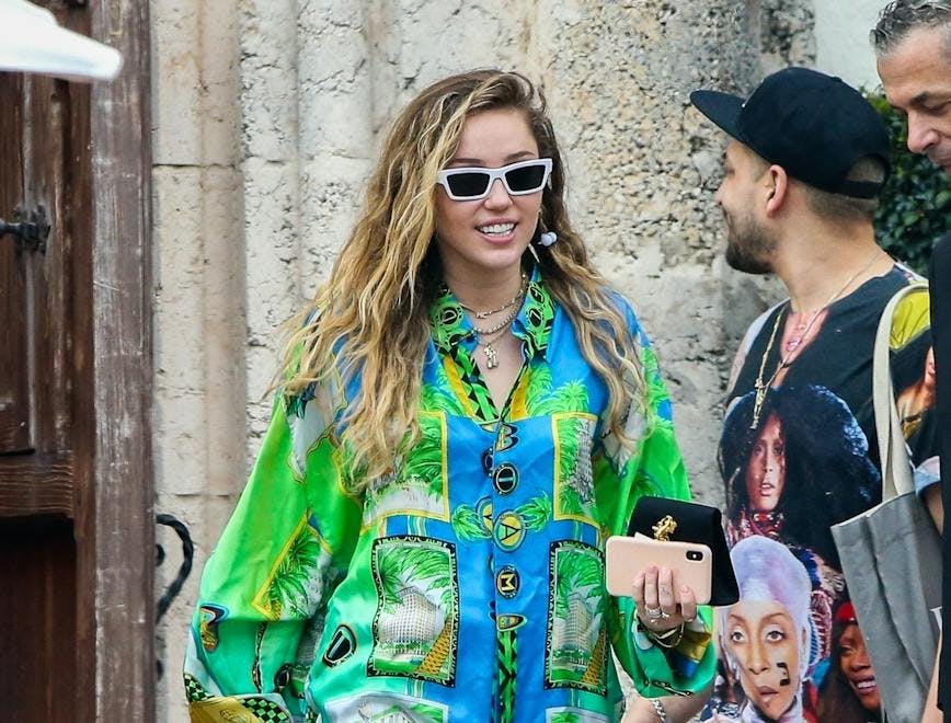 Miley Cyrus sports a Versace button down.