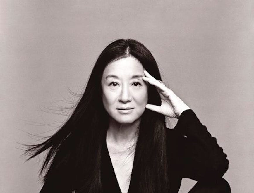 Vera Wang in a black top and pants posing for the camera.