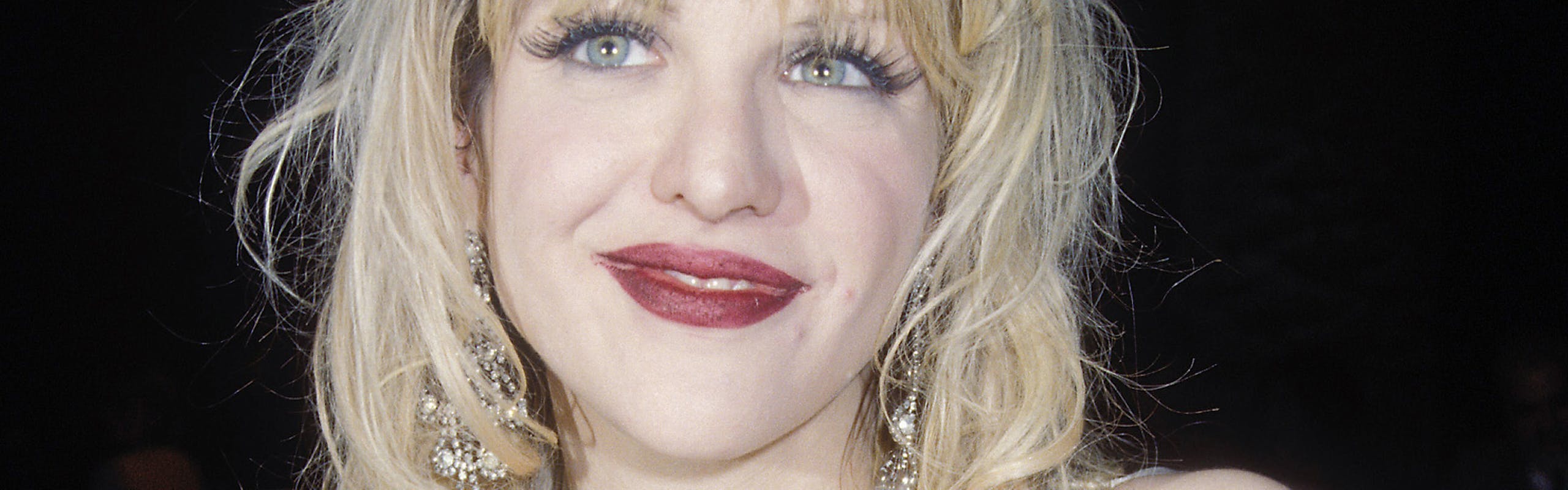 Courtney love in a tiara and silk blouse
