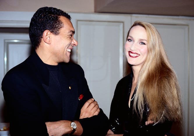 designer Bruce Oldfield wearing all black and model jerry hall standing beside one another princess diana british royalty