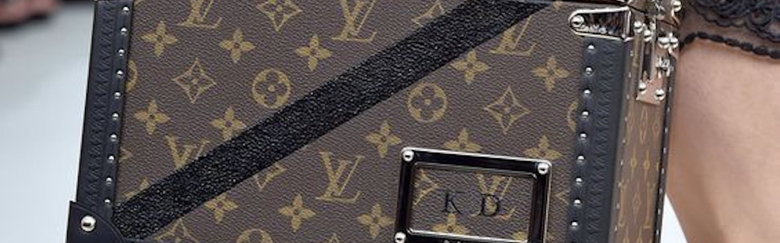 Monogrammed small LV luggage on the runway