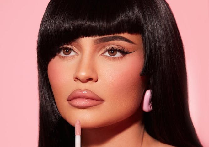 Kylie Jenner applying lip gloss in a Kylie Cosmetics campaign