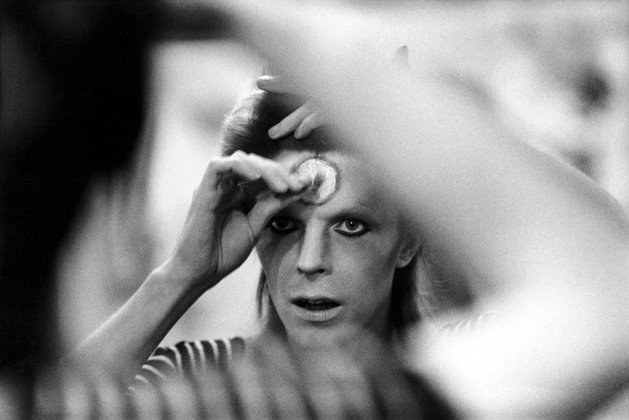 David Bowie doing his makeup