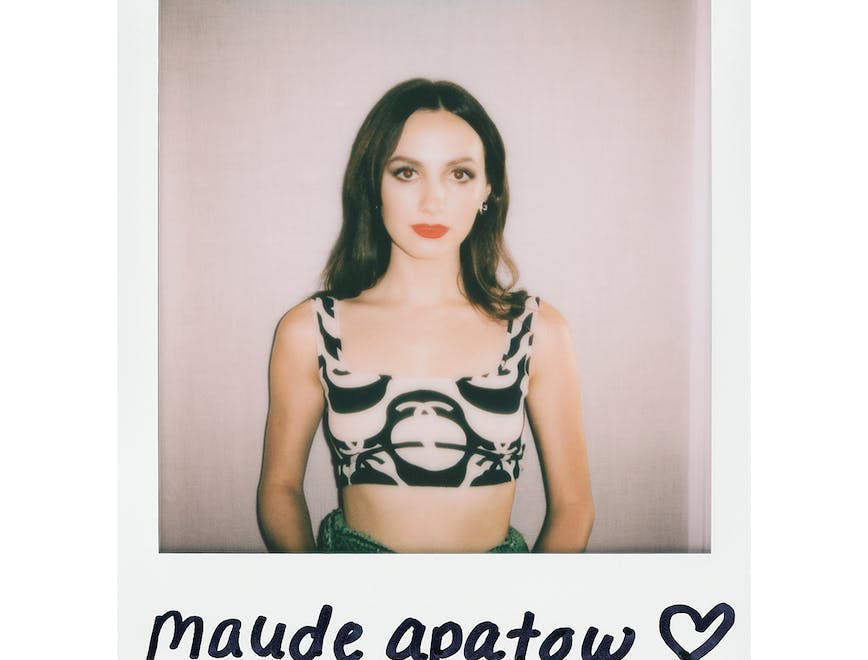 Polaroid of Maude Apatow in a black and white top