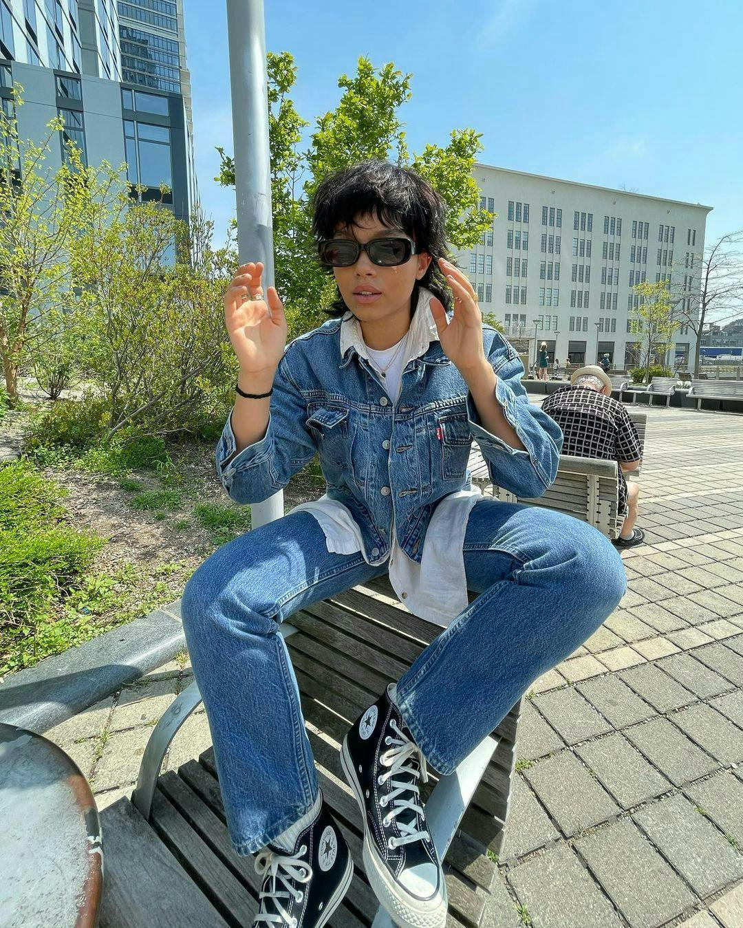 pants clothing apparel person jeans shoe footwear sunglasses accessories sitting