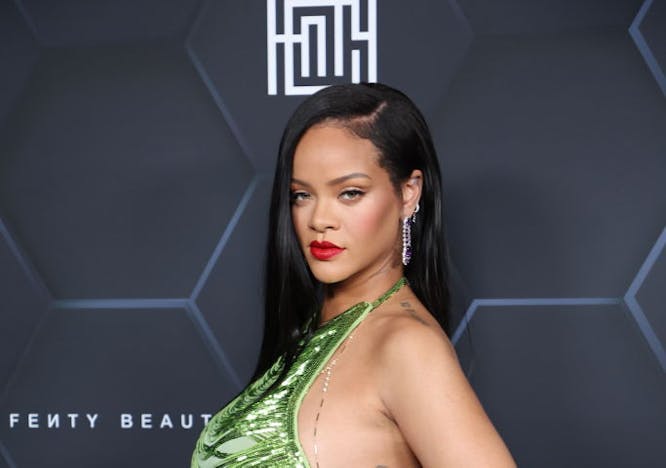 Rihanna in a green top and silver pants at a FENTY event