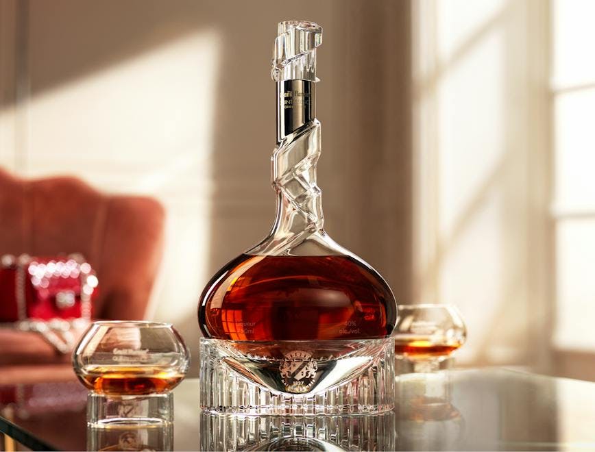 Grand Marnier Quintessence in a Baccarat Crystal Bottle on a Glass Table