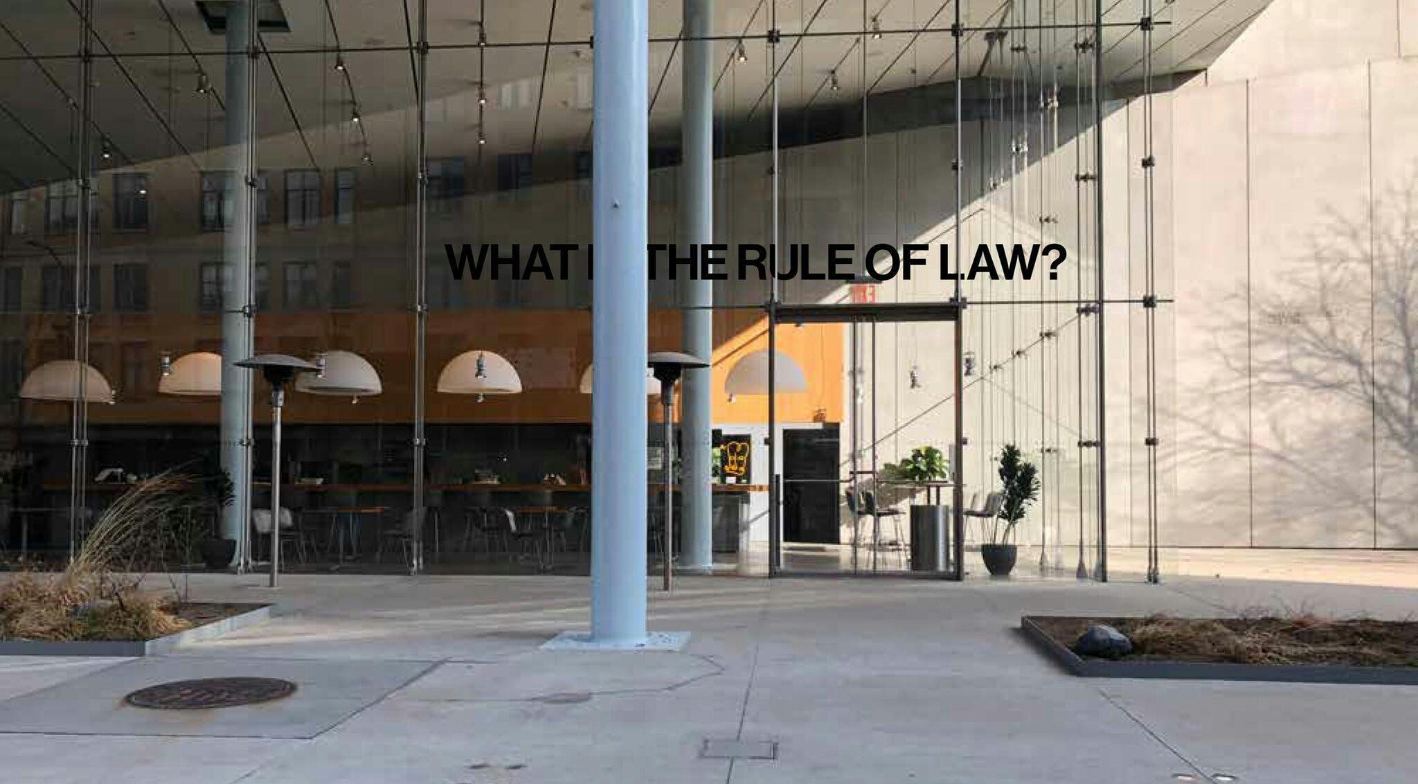 The outside of the Whitney Museum reading "What is the rule of the law?"