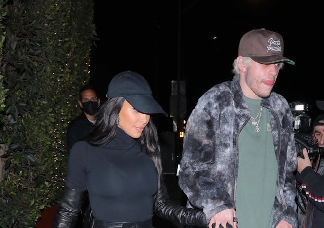 Kim Kardashian and Pete Davidson holding hands outside in a paparazzi photo