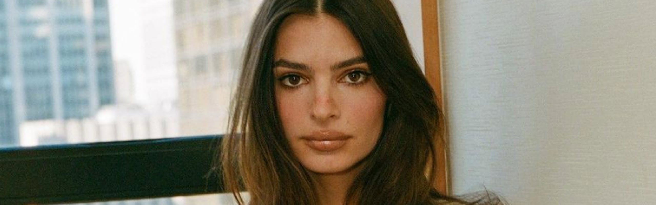 Model and actress Emily Ratajkowski holds her debut book, 'My Body.'