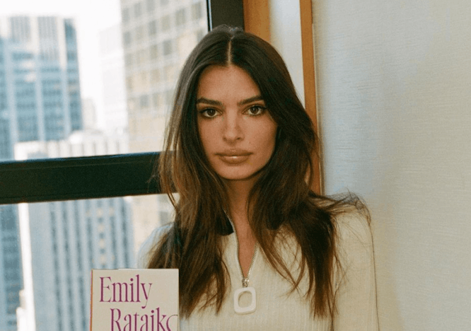 Model and actress Emily Ratajkowski holds her debut book, 'My Body.'
