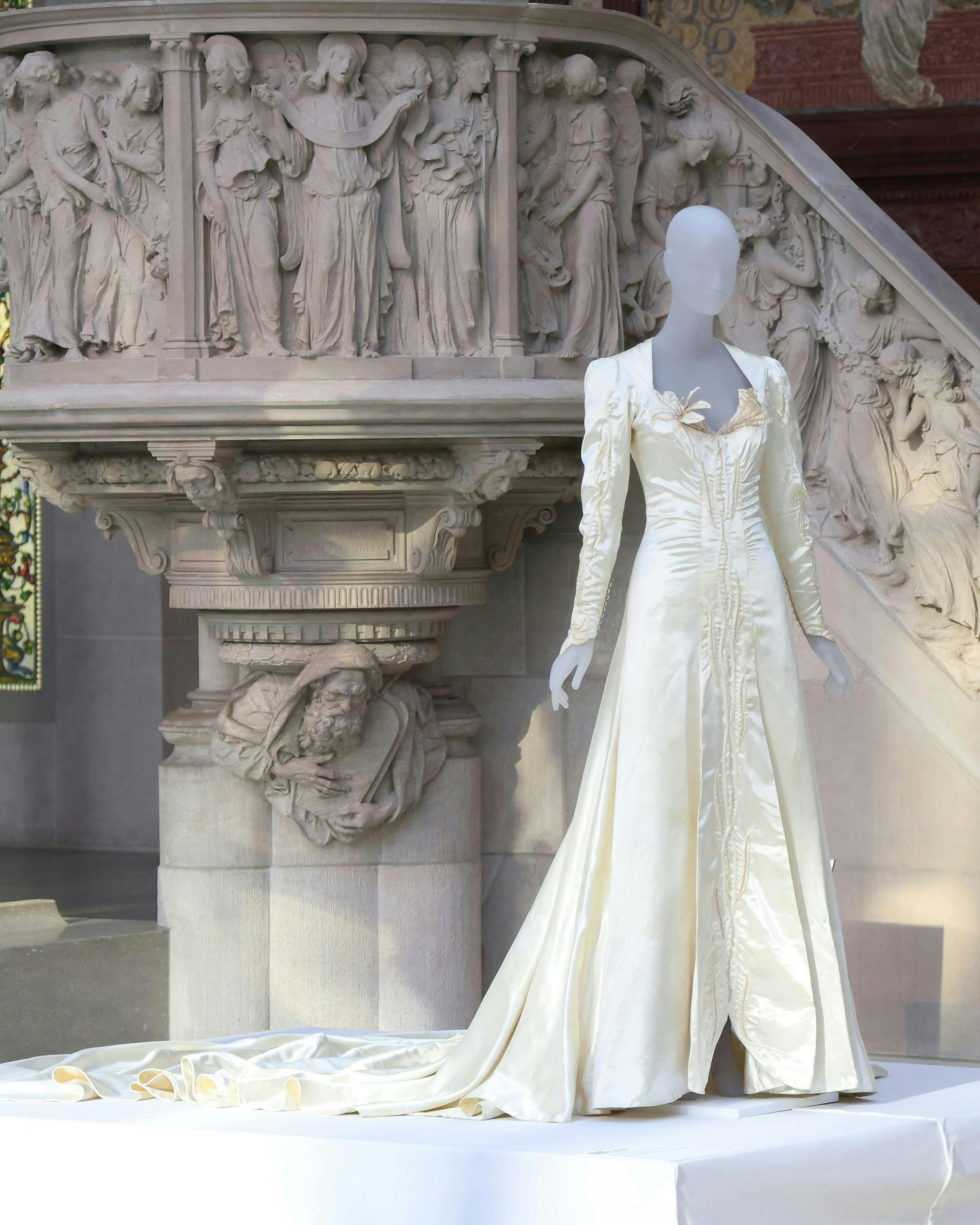 A white long sleeve dress on display at the Metropolitan museum of art for Vogue's lexicon of fashion