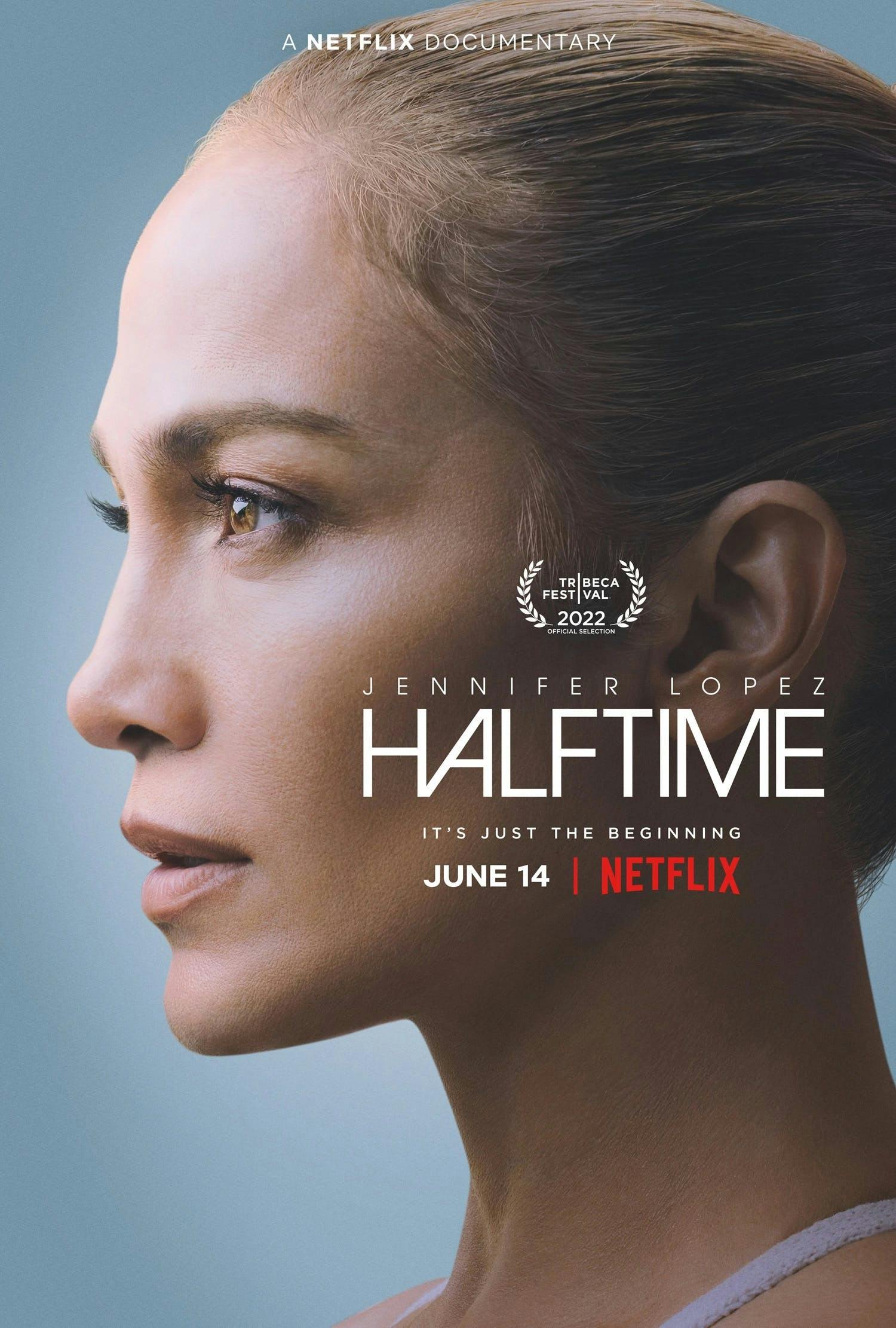 Jennifer Lopez poses in front of blue backdrop for her 'Halftime' movie poster 