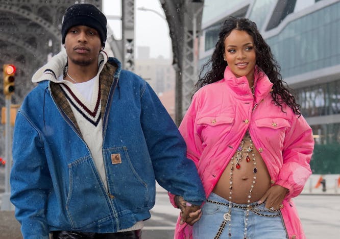 Preganant Rihanna and A$AP Rocky holding hands.