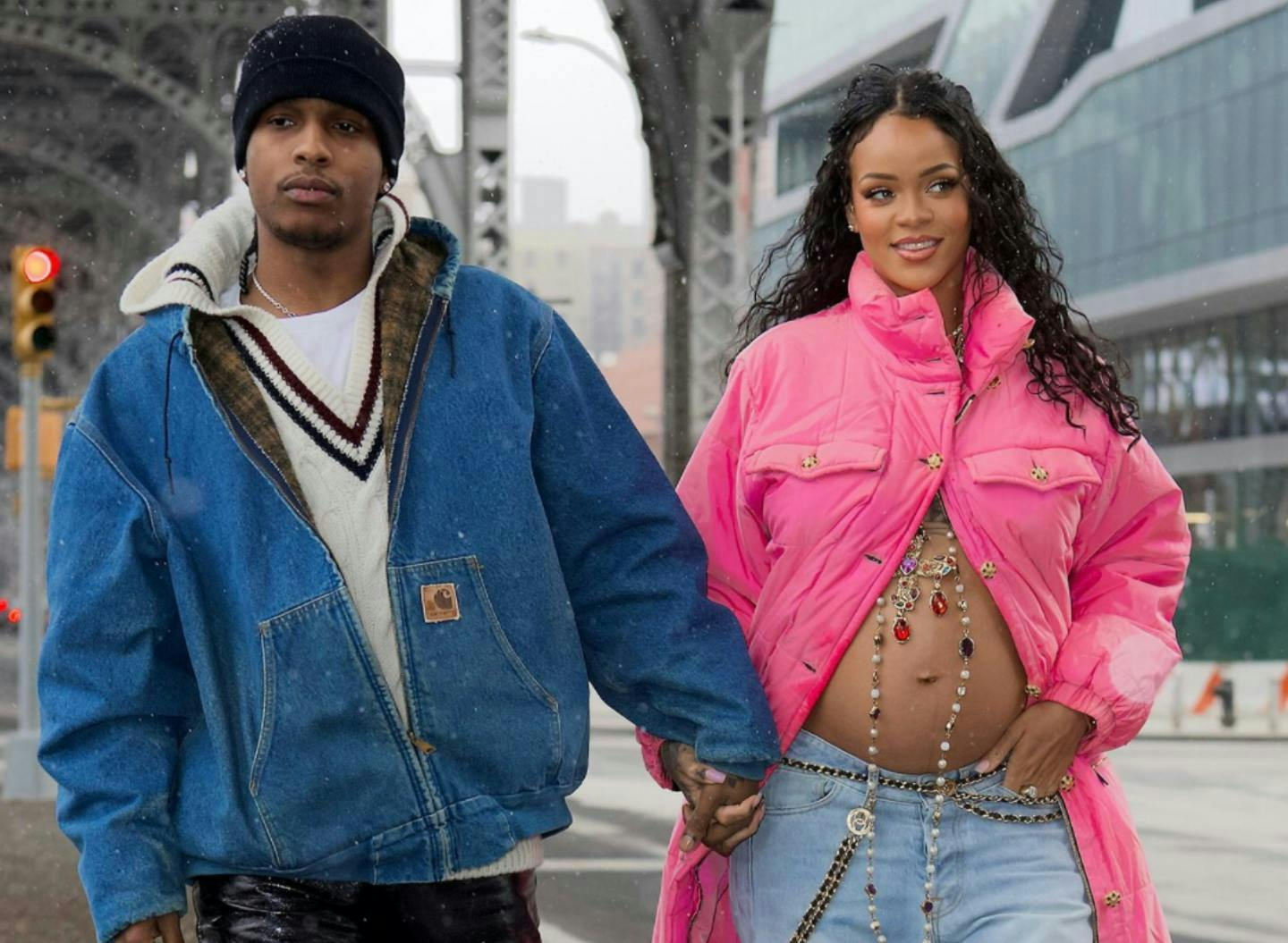Preganant Rihanna and A$AP Rocky holding hands.