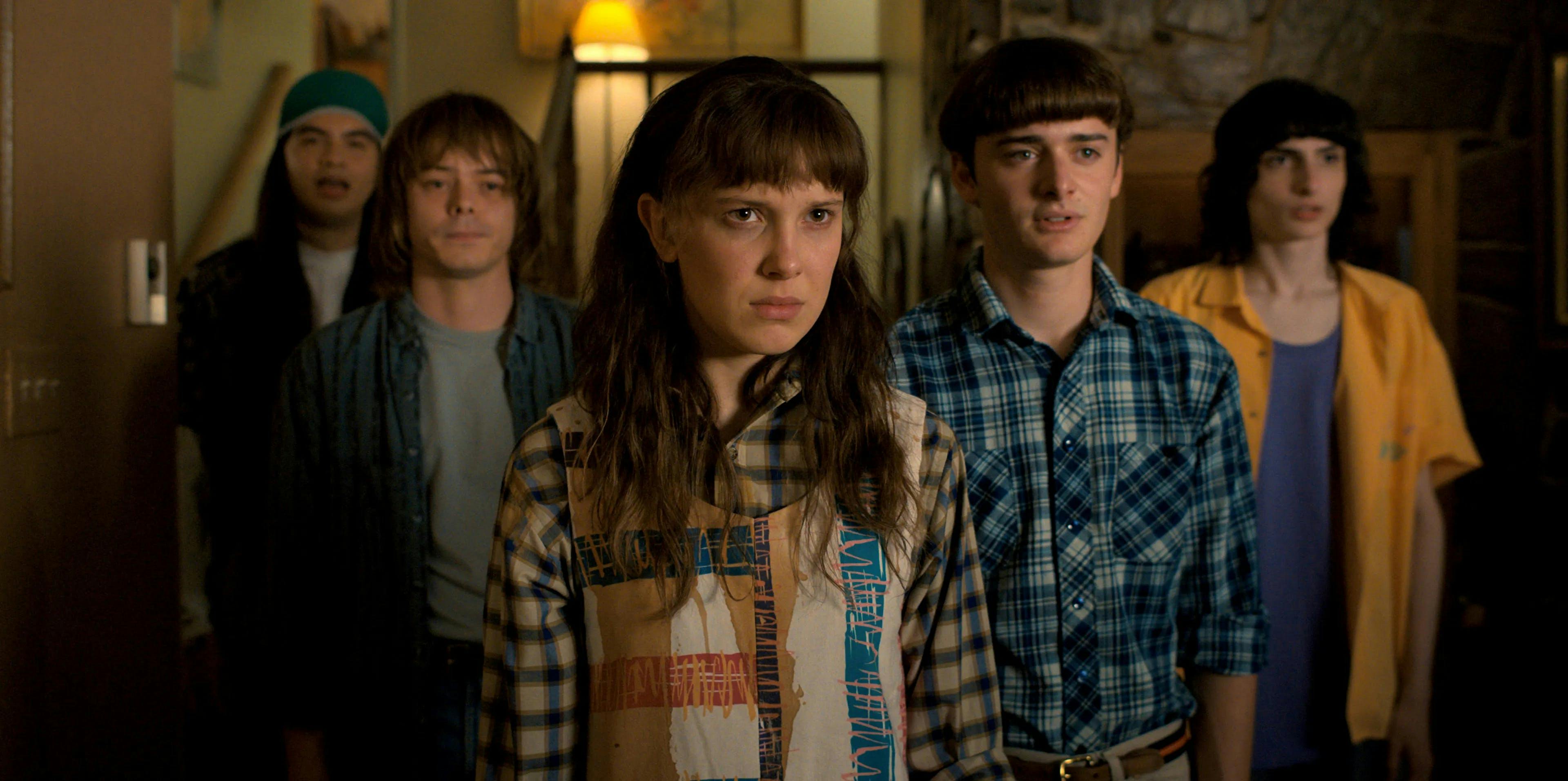 A still from Stranger Things season 4 of Eleven standing front and center with Argyle, Jonathan, Will and Mike standing behind her.