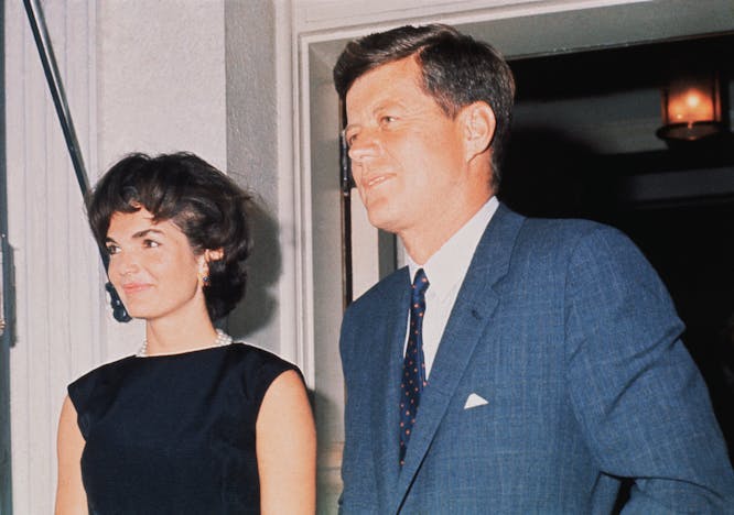 two people:cb2 prominent persons:cb1 support:cb1 government:cb1 washington dc:cb2 jacqueline bouvier kennedy onassis:cb1 john fitzgerald kennedy:cb1 person suit coat clothing tie accessories evening dress fashion blazer home decor