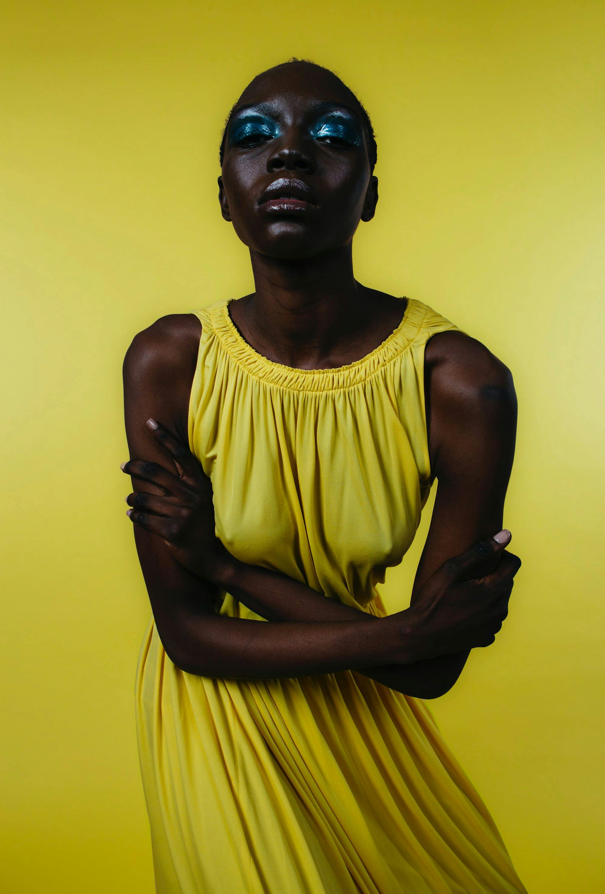 Photographed by Matt Colombo for L'OFFICIEL Art Spring 2022 yellow dress and background  blue eyeshadow 