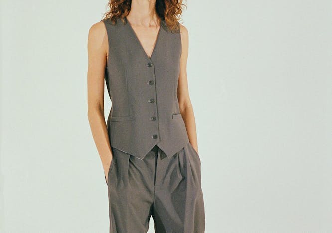 Woman in a vest and pant suit