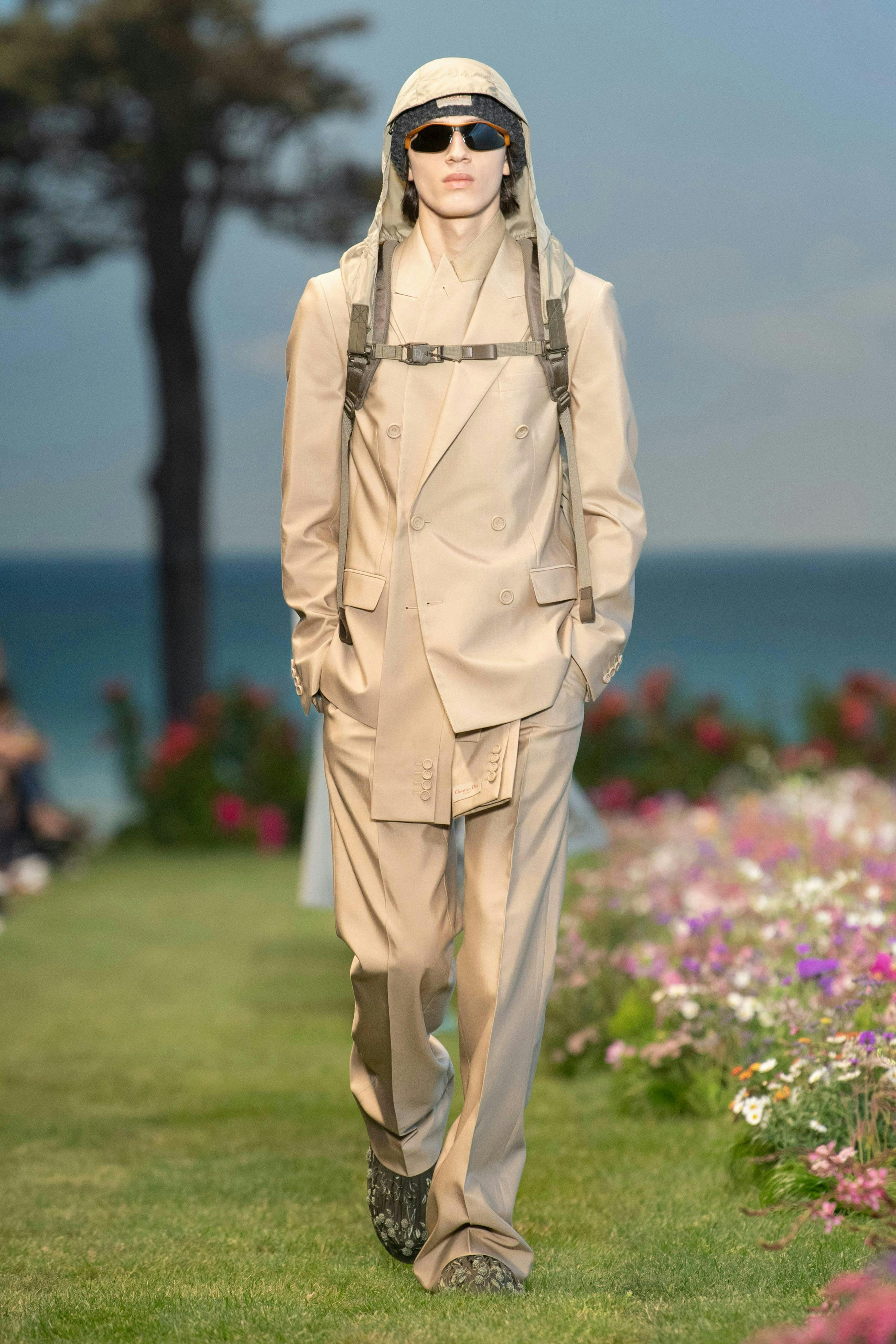 clothing apparel overcoat coat sunglasses accessories suit grass plant person
