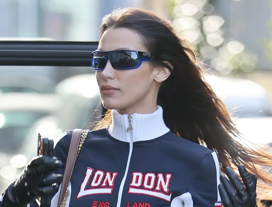 Bella Hadid photographed while wearing sunglasses and a jacket