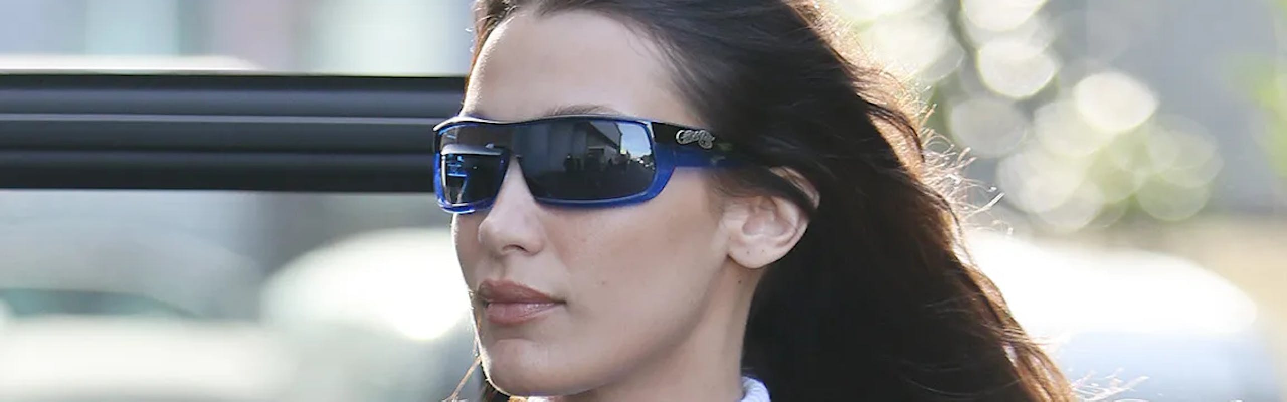 Bella Hadid photographed while wearing sunglasses and a jacket