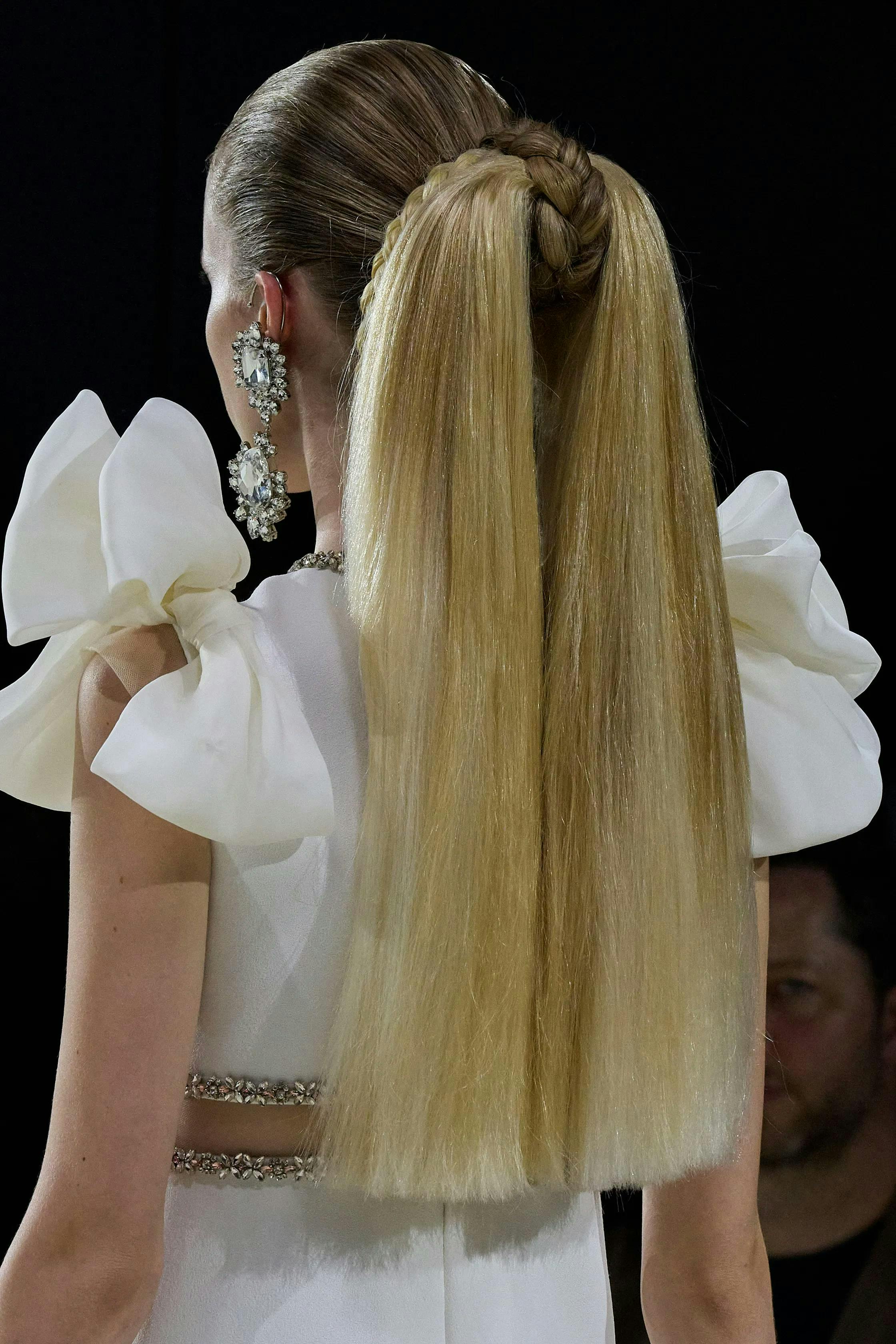 Model for Giambattista Valli with a long blonde ponytail.