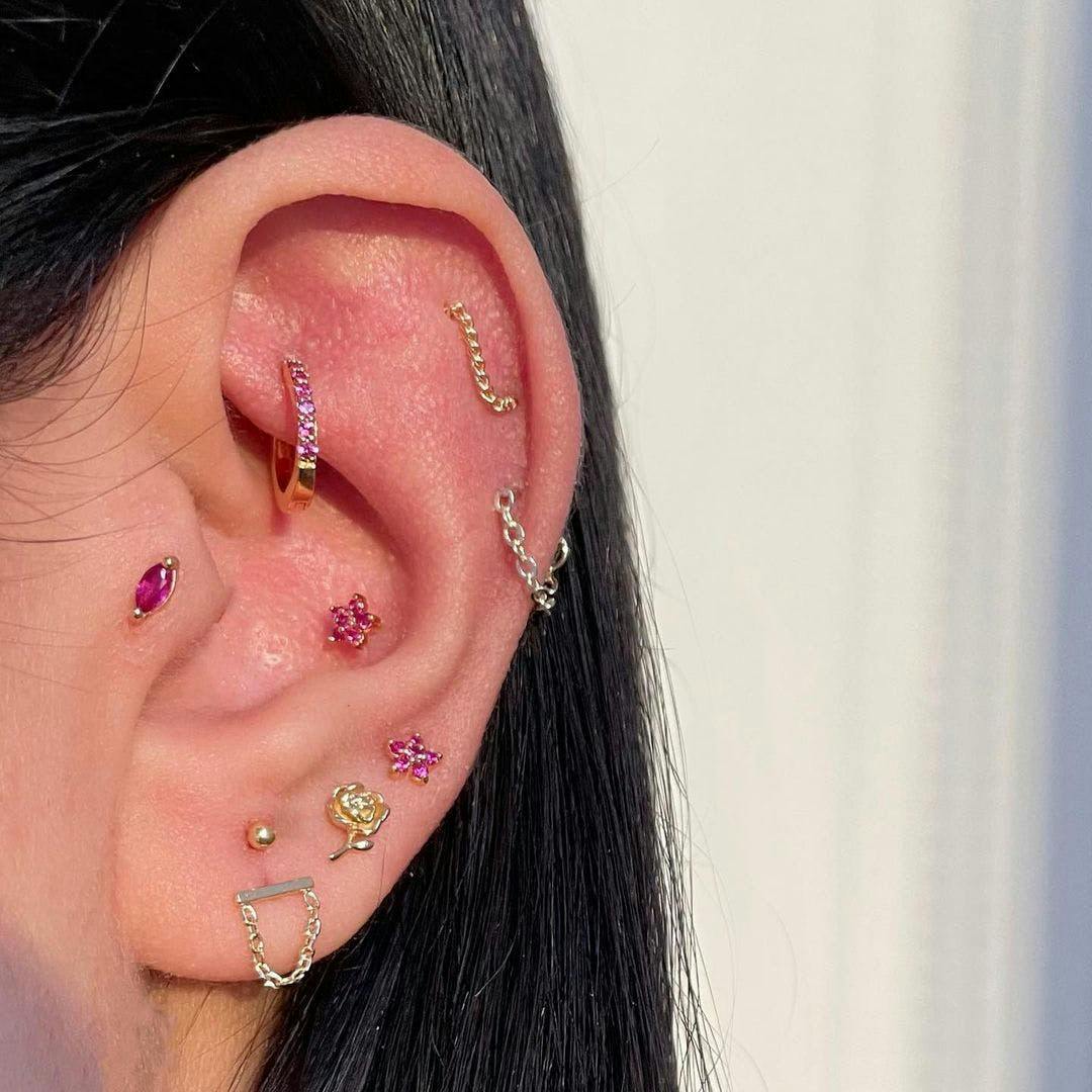 Close up photo of an ear with multiple piercings