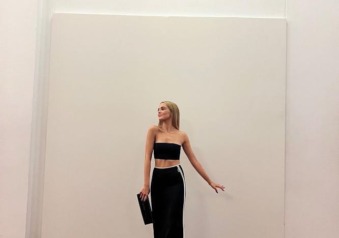 Zoe Deutch wearing a long black skirt and bandeau top