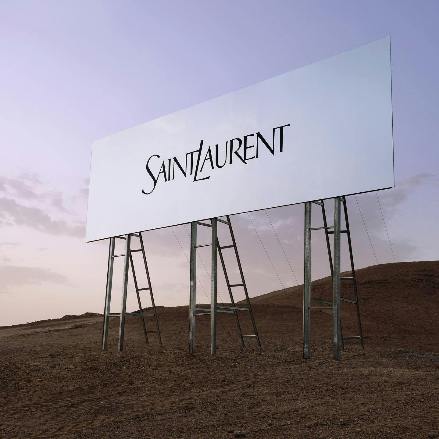 Billboard with the Saint Laurent logo on it in the middle of a desert.