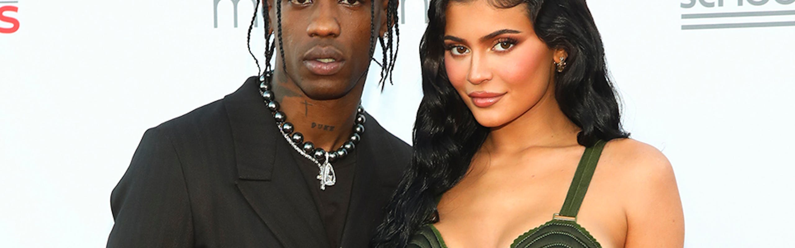 Travis Scott and Kylie Jenner pose for a photo on the red carpet. 