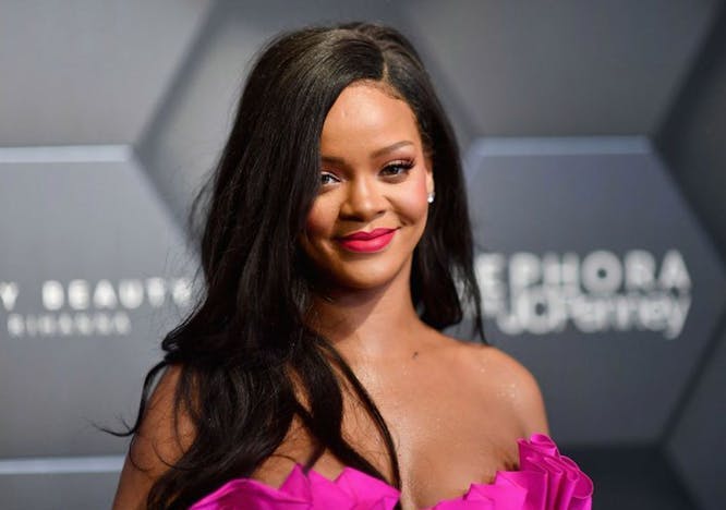 Rihanna wearing a pink top on the Fenty Beauty red carpet